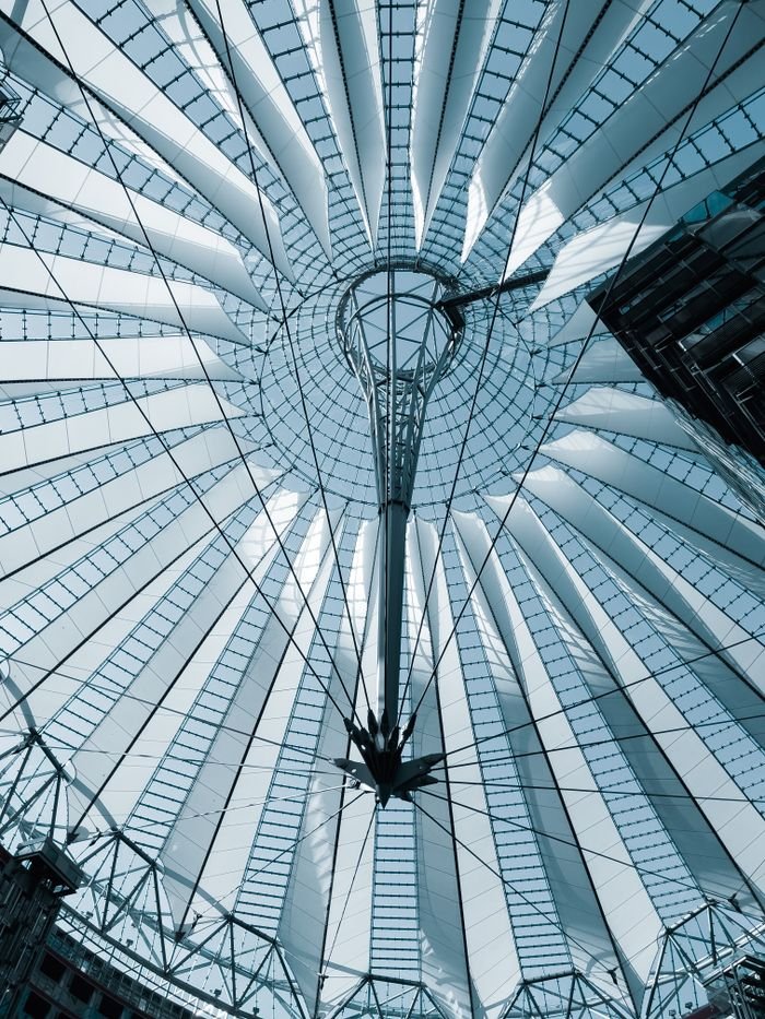 services-01 A striking view of the modern architectural structure in Berlin, showcasing geometric lines and steel framework.